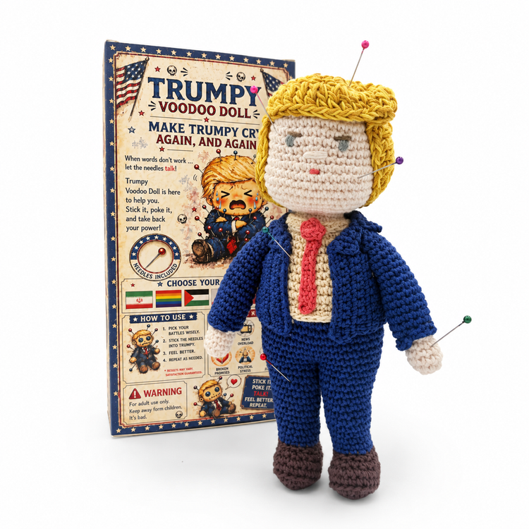Crochet Trumpy doll with colorful pins, a navy suit and red tie, standing in front of the back of its collector box.
