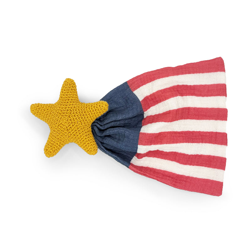 Yellow crochet star attached to a red, white and blue American flag-inspired lovey blanket.